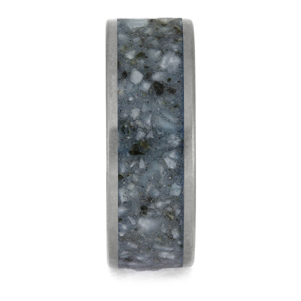 Ring with a textured gray and black band on a white background