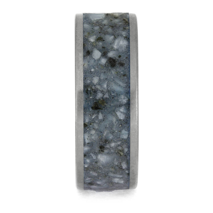 Ring with a textured gray and black band on a white background