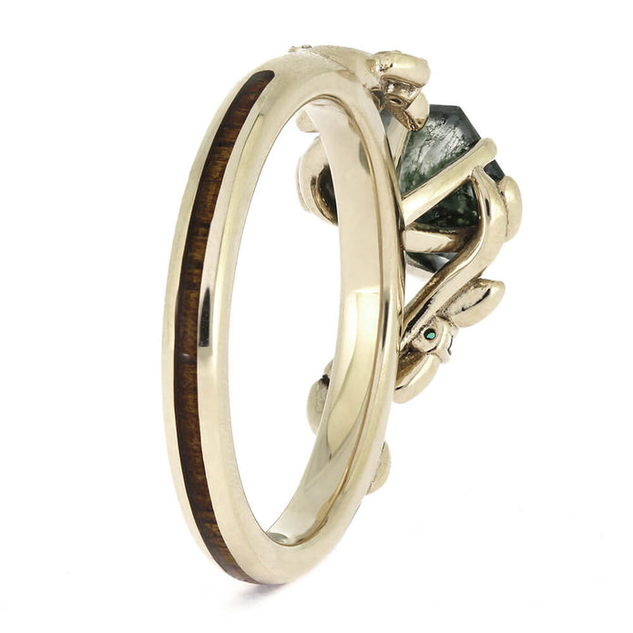Gold ring with a green gemstone on a white background