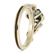 Gold ring with a green gemstone on a white background