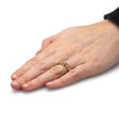 Hand wearing a ring with a white background