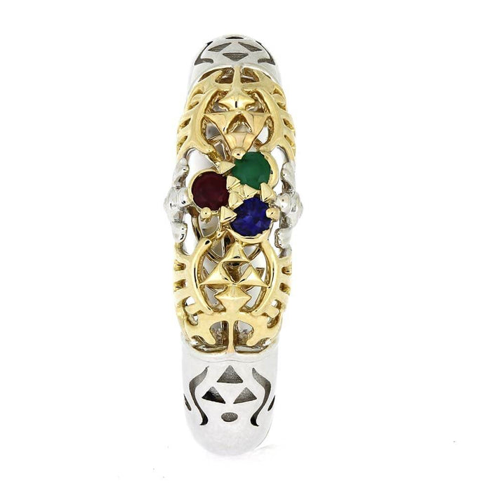Gold and silver ring with colored gemstones on a white background