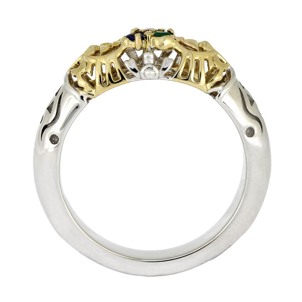Two-tone gold and silver ring with gemstones on a white background