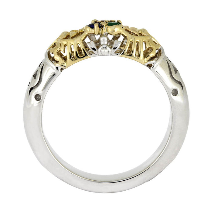 Two-tone gold and silver ring with gemstones on a white background