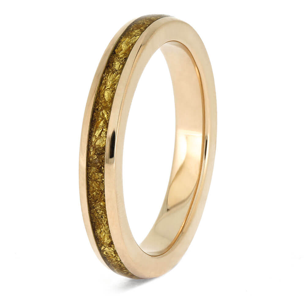 Angled view of 14k rose gold wedding band for women with gold foil inlay and polished round profile, designed for classic wedding style.