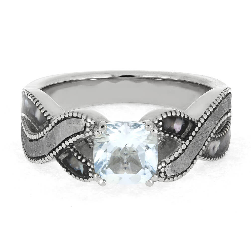 Silver ring with a blue gemstone on a white background
