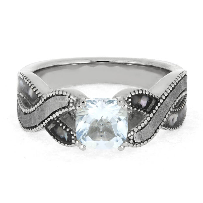 Silver ring with a blue gemstone on a white background