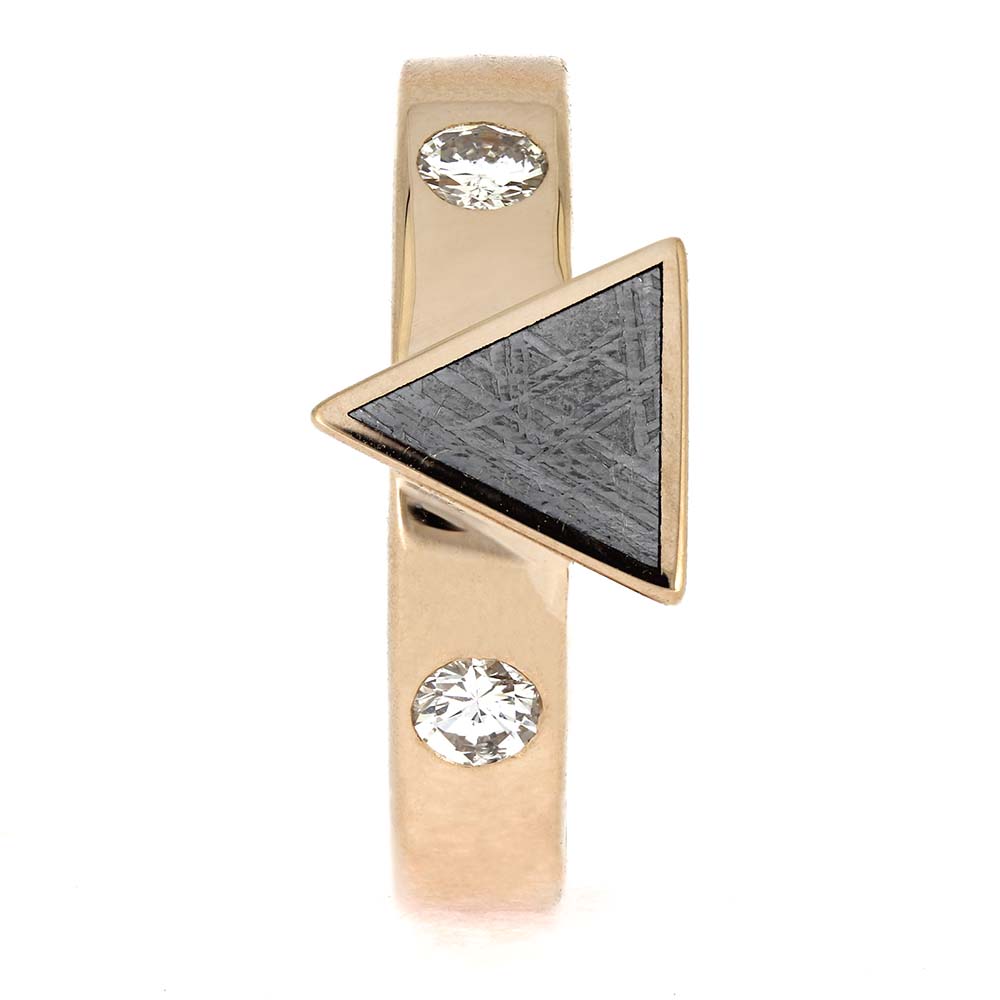 Gold earring with triangular design and two clear gemstones on a white background