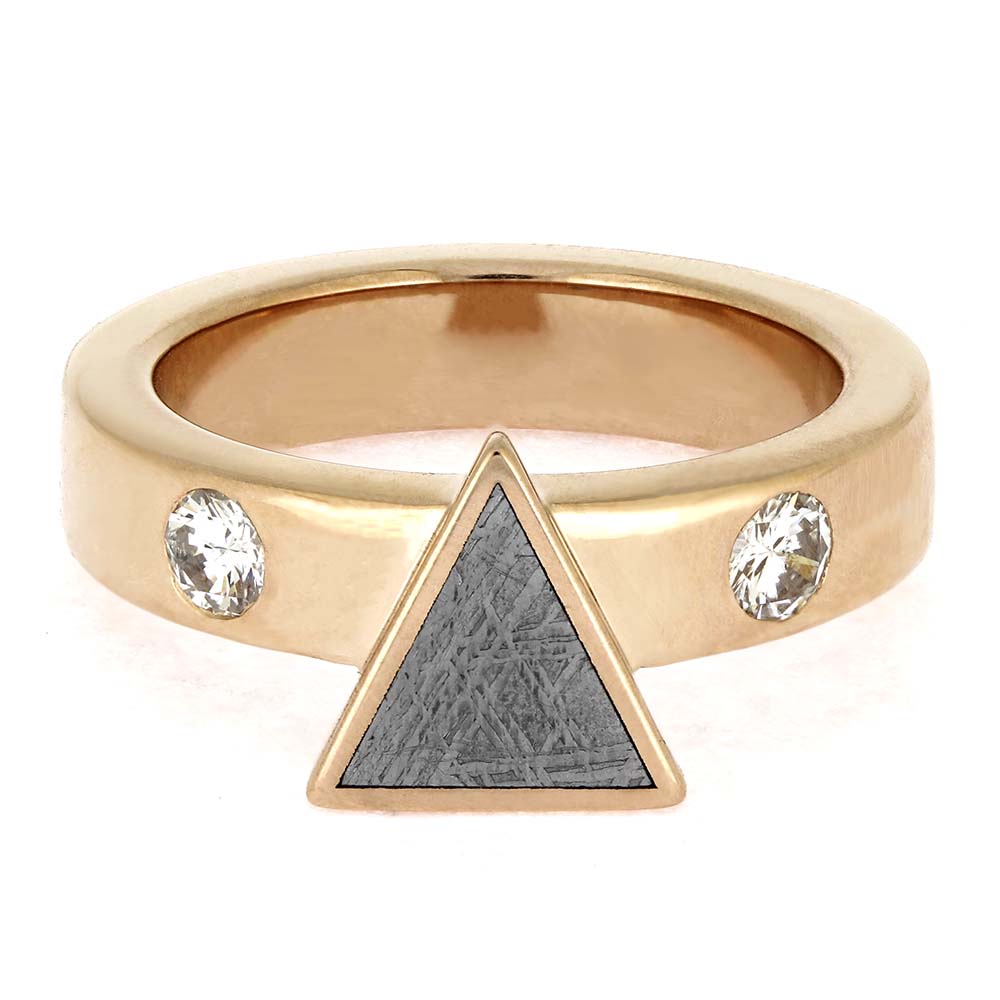 Gold ring with a triangle and gemstones on a white background