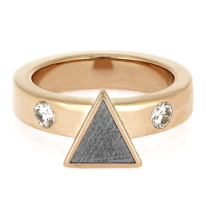 Gold ring with a triangle and gemstones on a white background