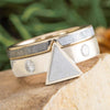 Gold and silver ring with geometric design on a natural background