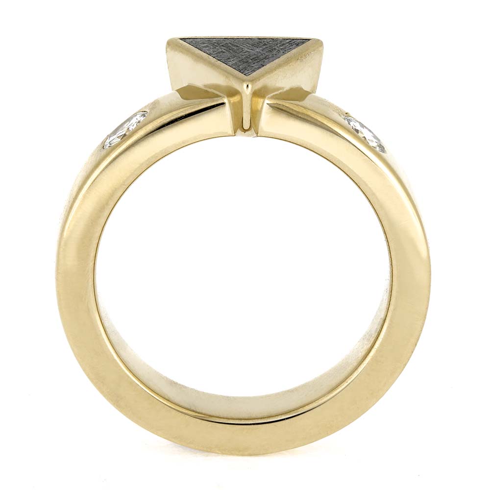 Gold ring with a triangular stone and smaller stones on a white background