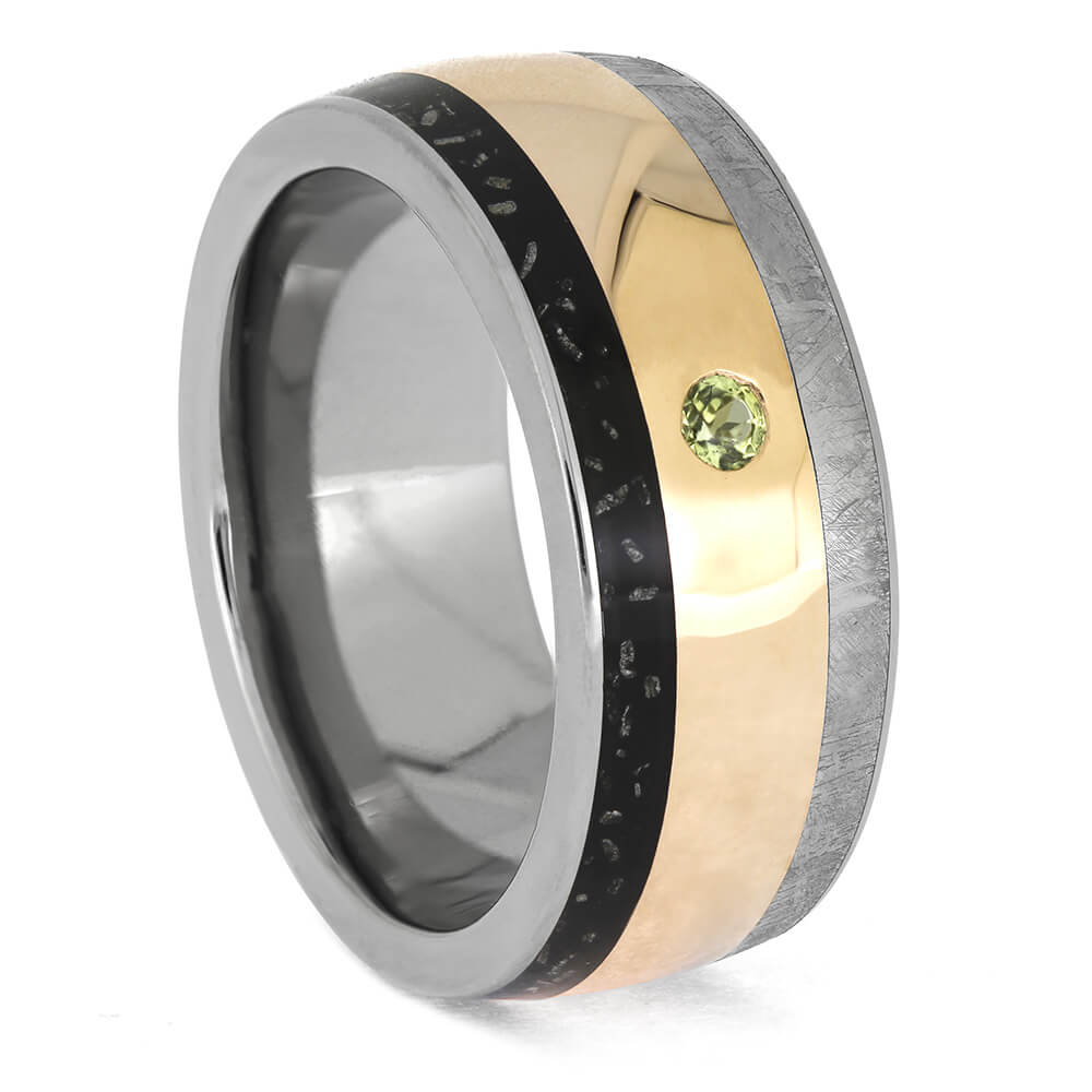 Triple inlay men's meteorite ring with rose gold center, Gibeon meteorite, and peridot gemstone. Cosmic wedding band in polished titanium.
