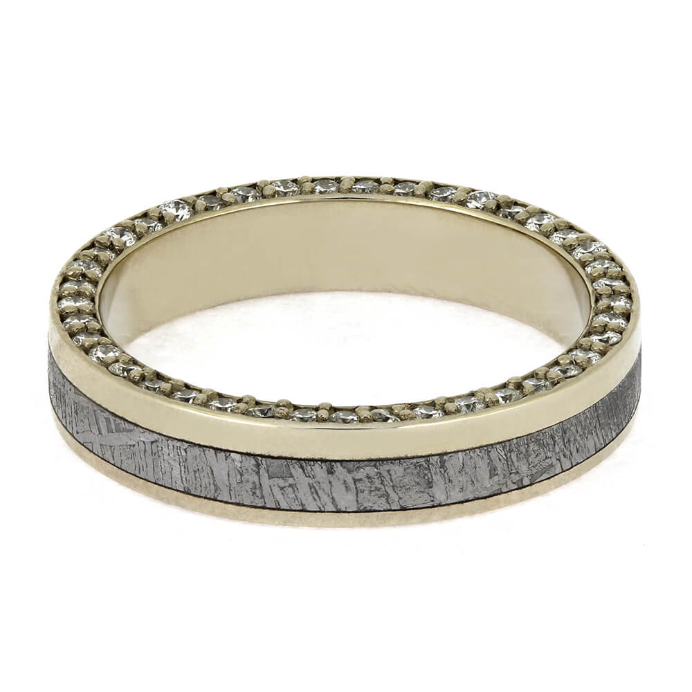 Gold ring with gray textured band and diamond accents on a white background