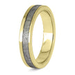 Gold ring with a textured gray center on a white background