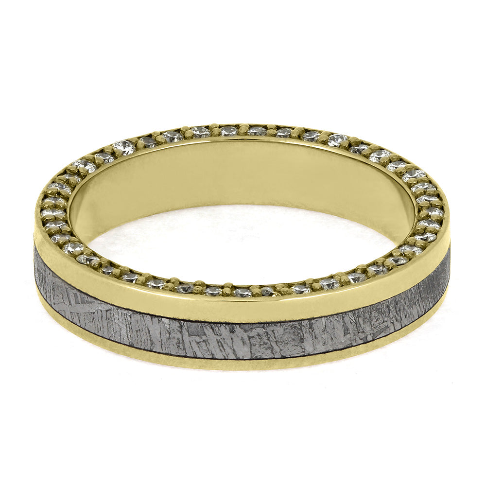 Gold ring with embedded stones and a wooden inlay on a white background