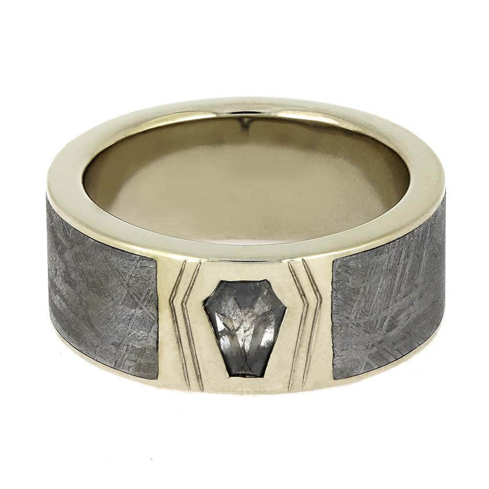 Gold ring with gray stone inlay on a white background