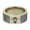 Gold ring with gray stone inlay on a white background