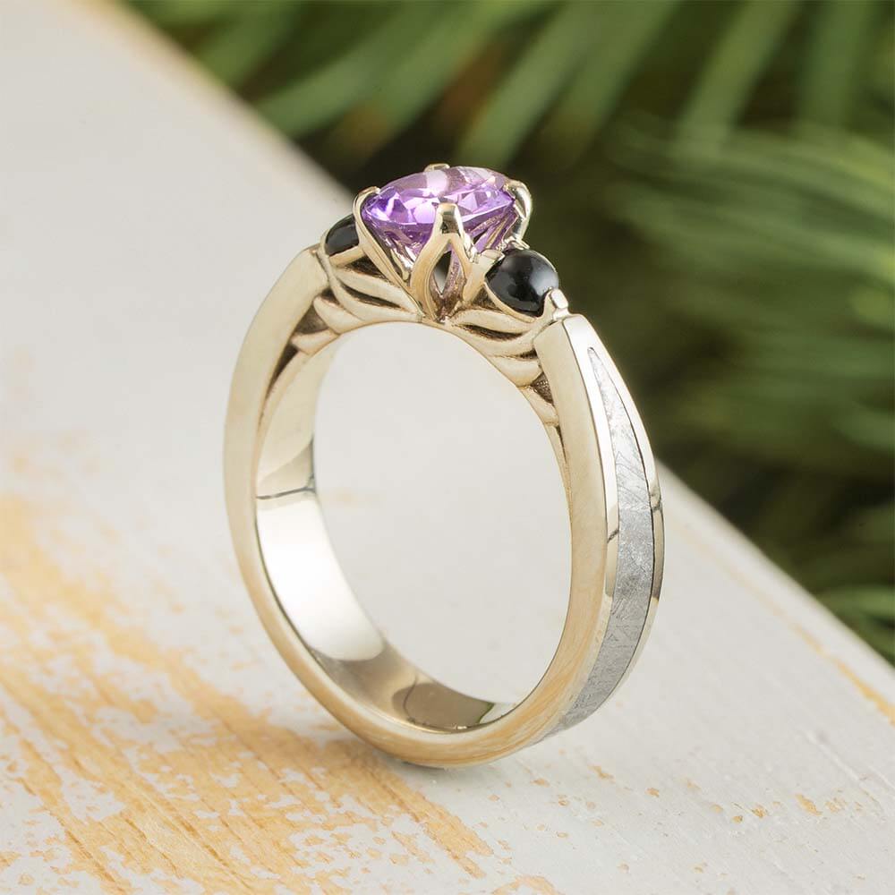 Three Stone Ring with Onyx & Meteorite featuring an oval-cut alexandrite center stone in 14k gold with black onyx side stones and meteorite inlay.