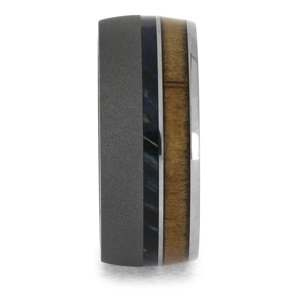 Ring with black and wooden band on a white background