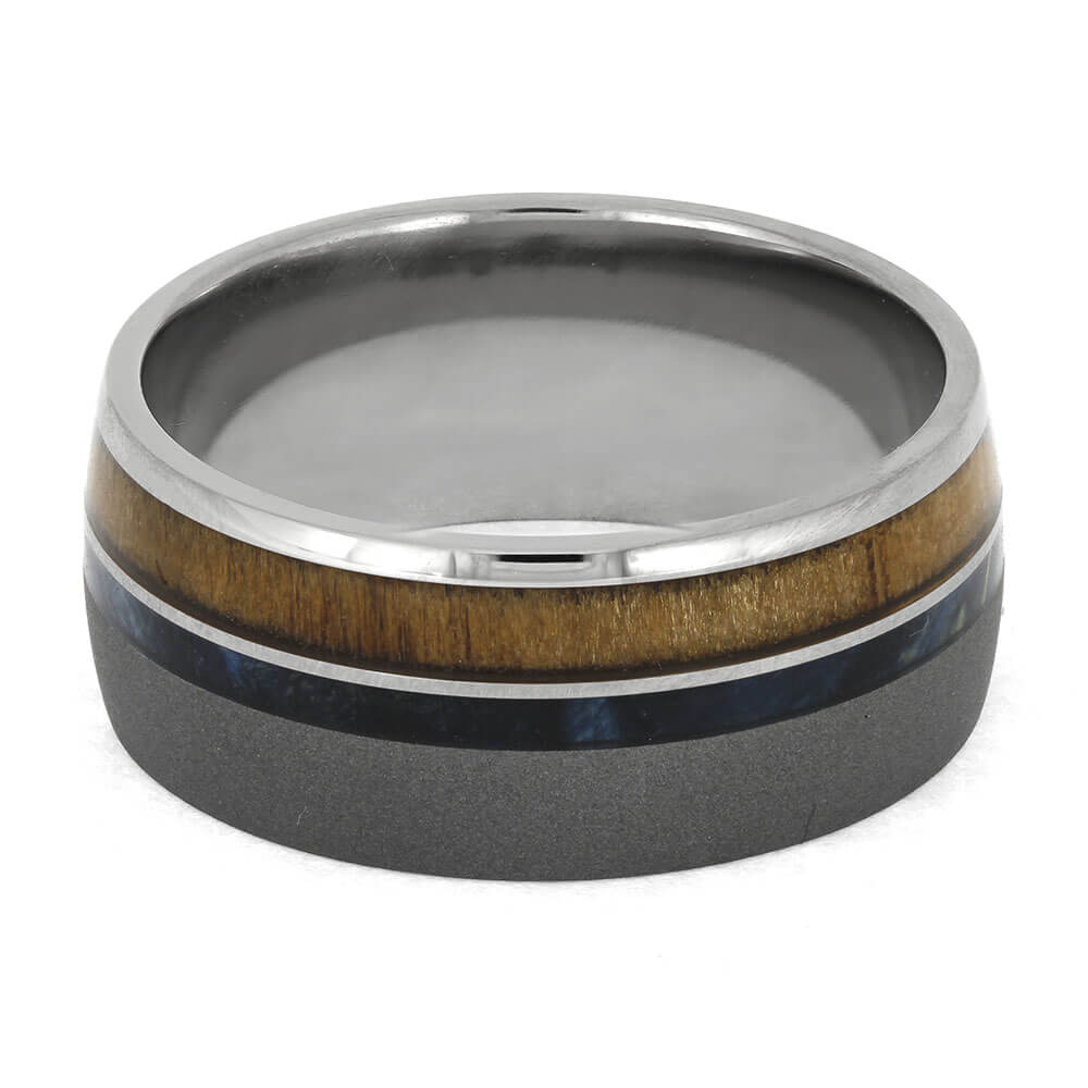 Multicolored ring with wooden and metallic band on a white background