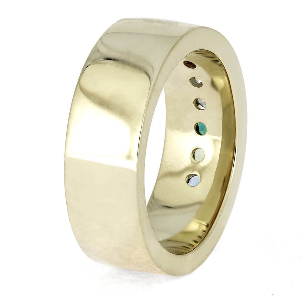 Gold ring with embedded gemstones on a white background