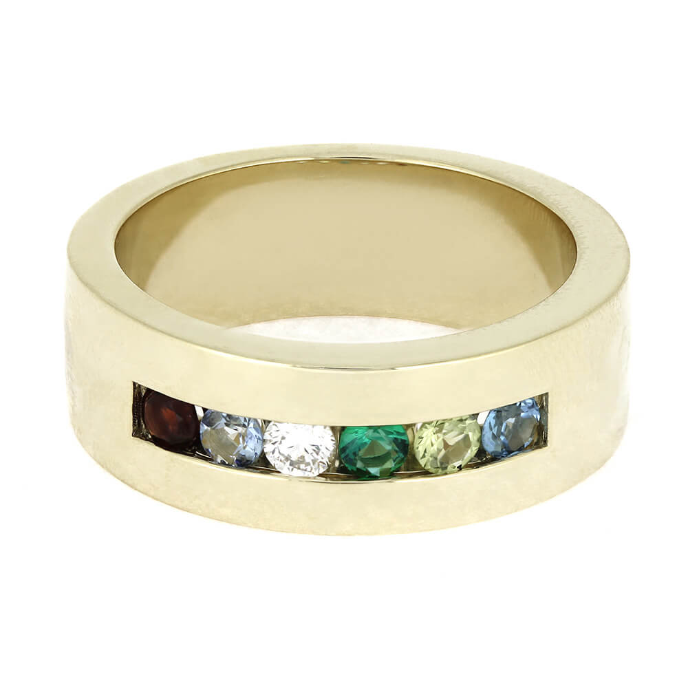 Gold ring with embedded colorful gemstones on a white background