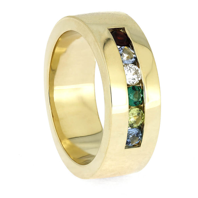 Gold ring with embedded colorful gemstones on a white background