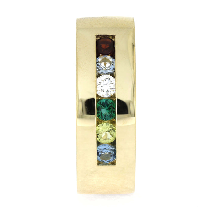 Gold ring with colorful gemstones on a white background
