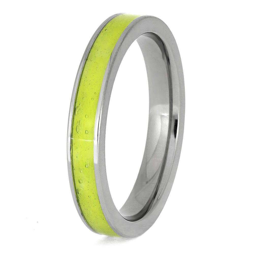 Tennis ball ring with a green interior and silver exterior on a white background