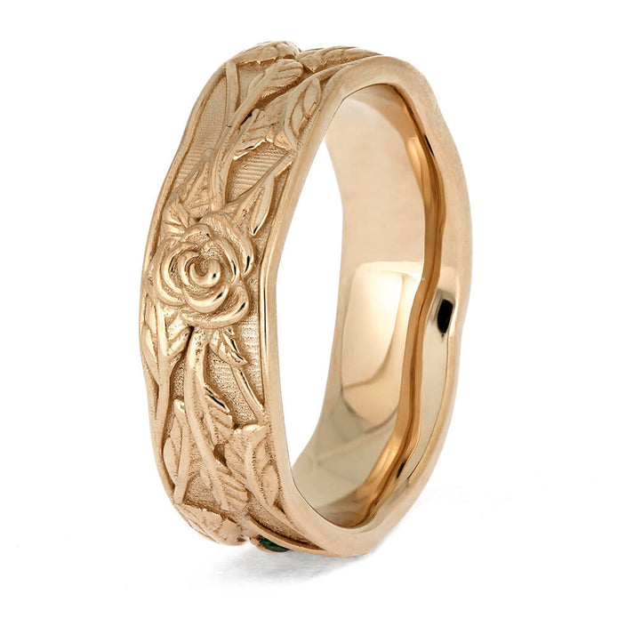 Rose gold ring with floral engraving on a white background