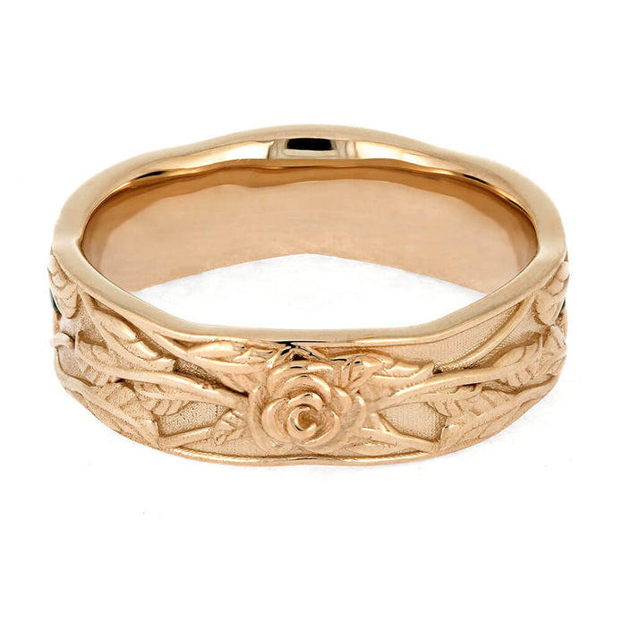 Gold ring with intricate floral design on a white background
