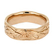 Gold ring with intricate floral design on a white background