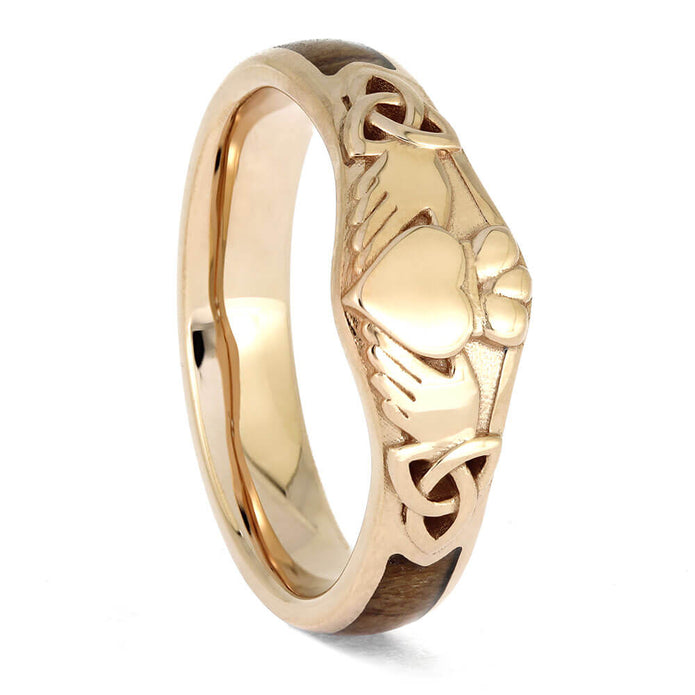 Gold ring with intricate design on a white background