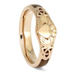 Gold ring with intricate design on a white background