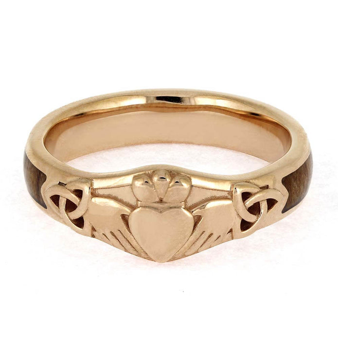 Gold Claddagh ring on a white background