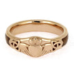 Gold Claddagh ring on a white background
