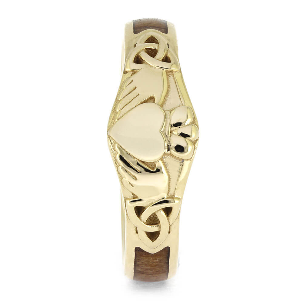 Gold ring with intricate design on a white background