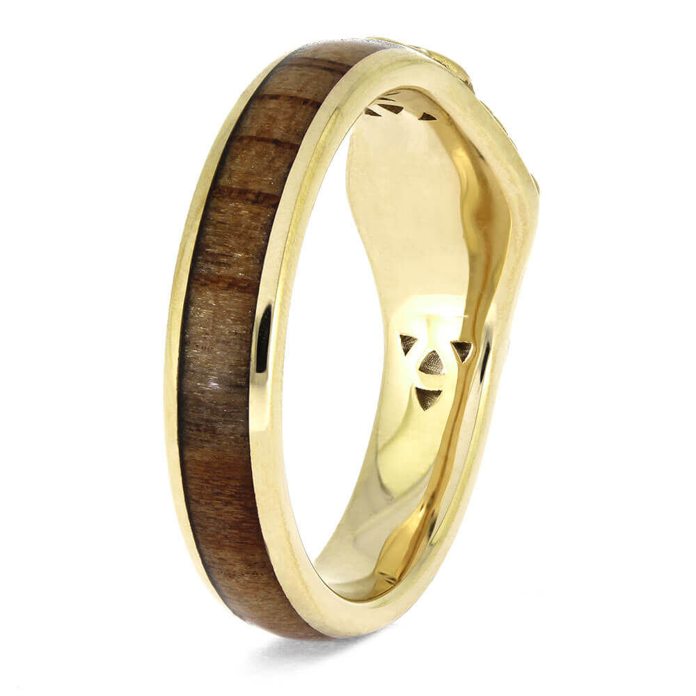 Gold ring with a wooden inlay on a white background