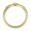 Gold ring with intricate design on a white background