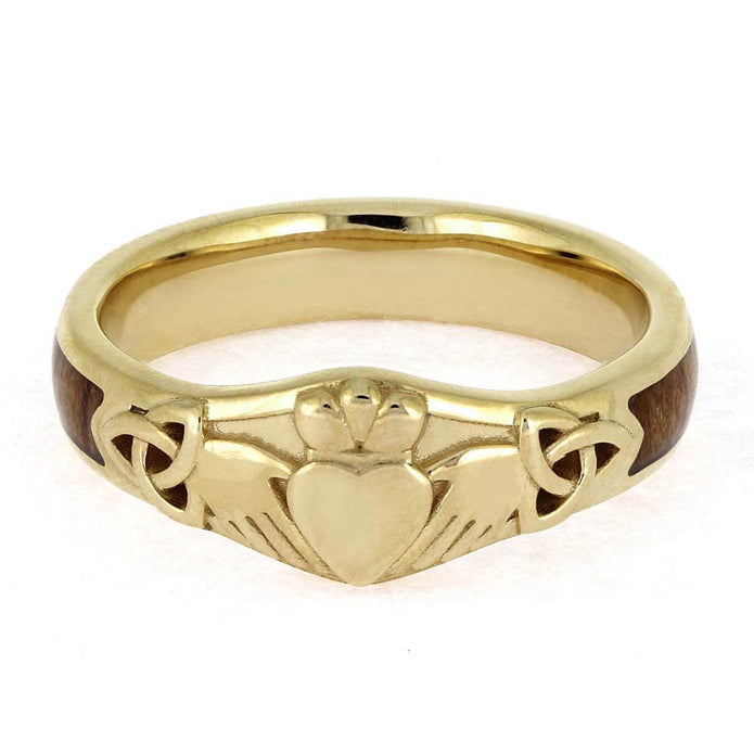 Gold ring with claddagh design on a white background