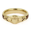 Gold ring with claddagh design on a white background