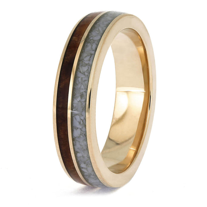 Gold ring with a wooden and gray inlay on a white background