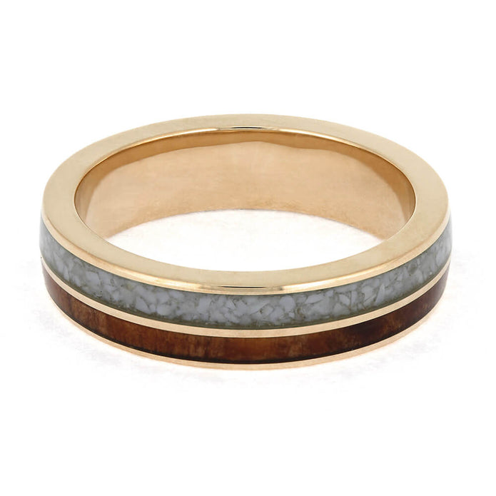 Gold ring with gray and brown inlay on a white background