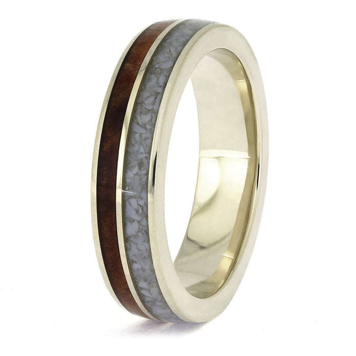 Gold ring with a wooden and gray inlay on a white background