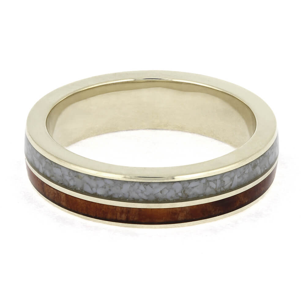 Gold ring with gray and brown inlay on a white background