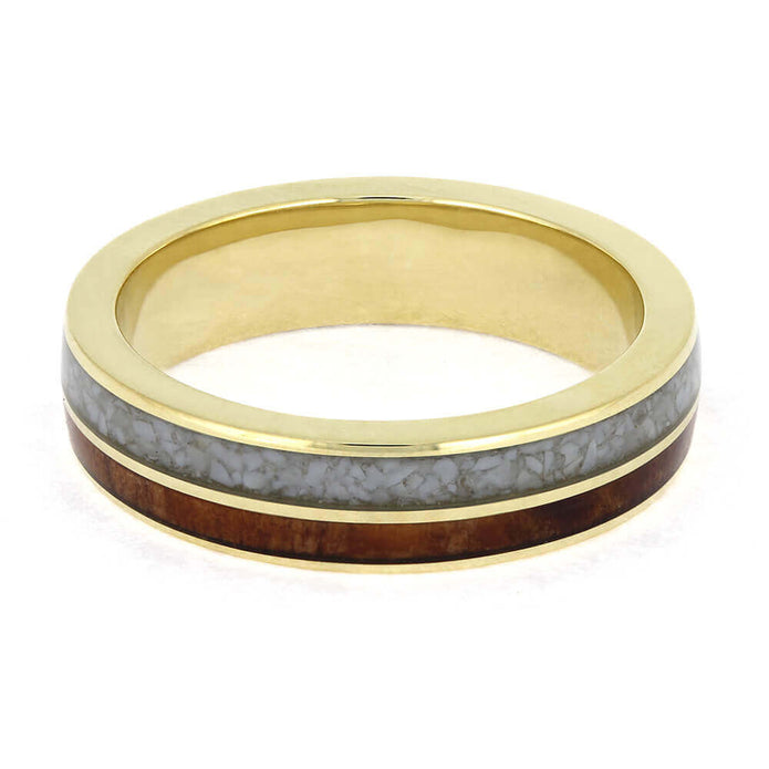 Gold ring with a gray and brown inlay on a white background