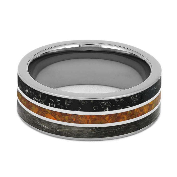 Silver ring with black and orange inlay on a white background
