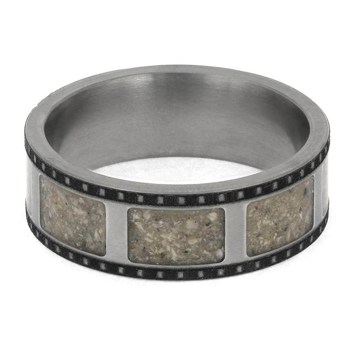 Silver ring with embedded stone-like material on a white background