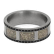 Silver ring with embedded stone-like material on a white background